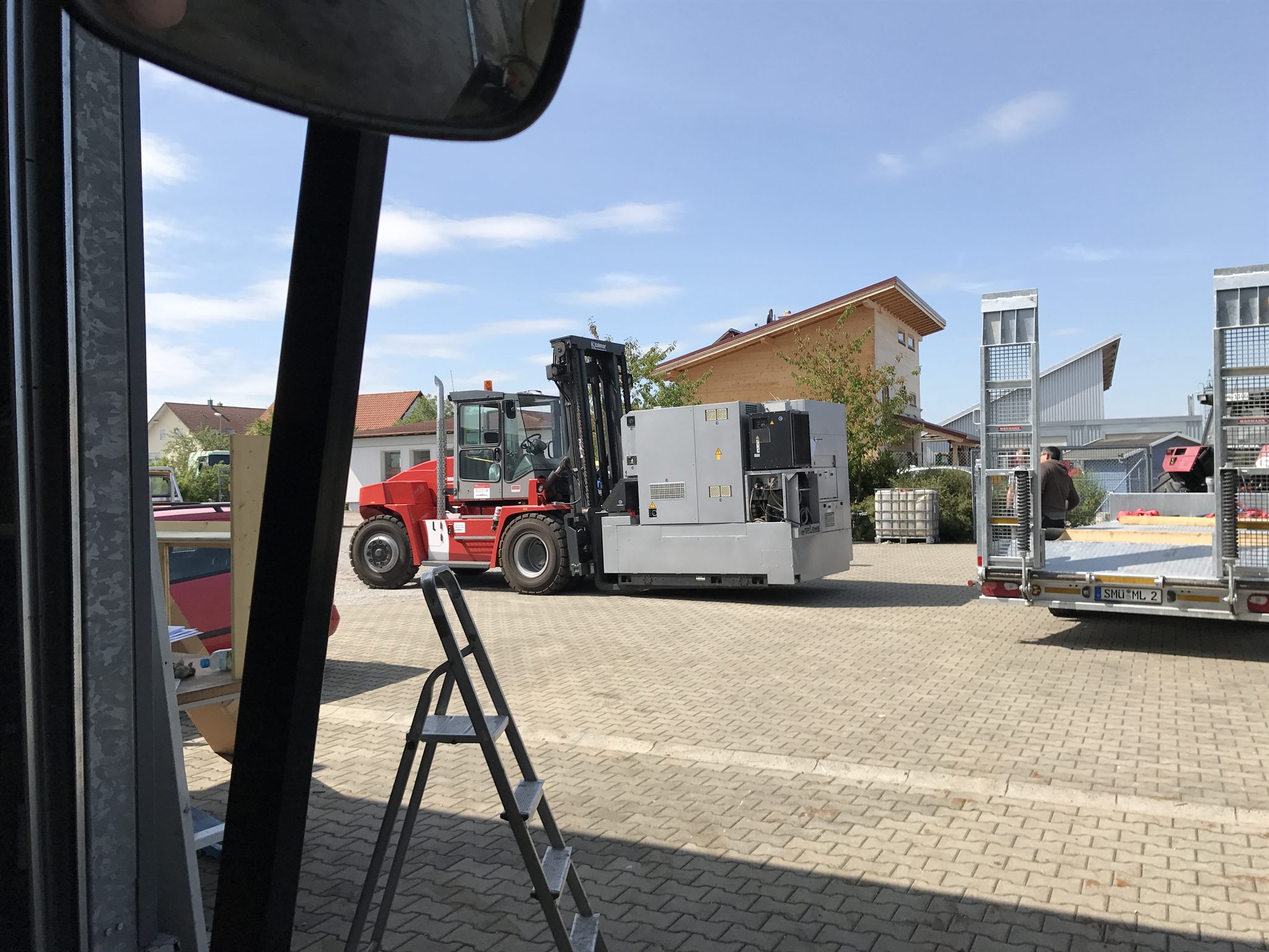 Blick aus dem Hallentor: der Stapler bringt die nächste Anlage über den Hof